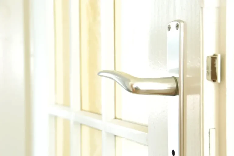 How to change a uPVC door lock in Hucknall – white door with a lever handle on a long backplate, Locksmith Hucknall guide to barrel, handle and multipoint replacement
